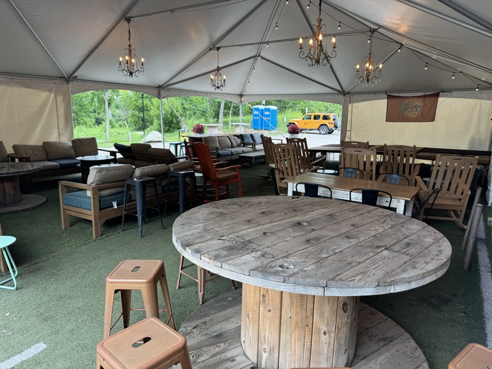 The Tent interior with chandeliers and rustic tables